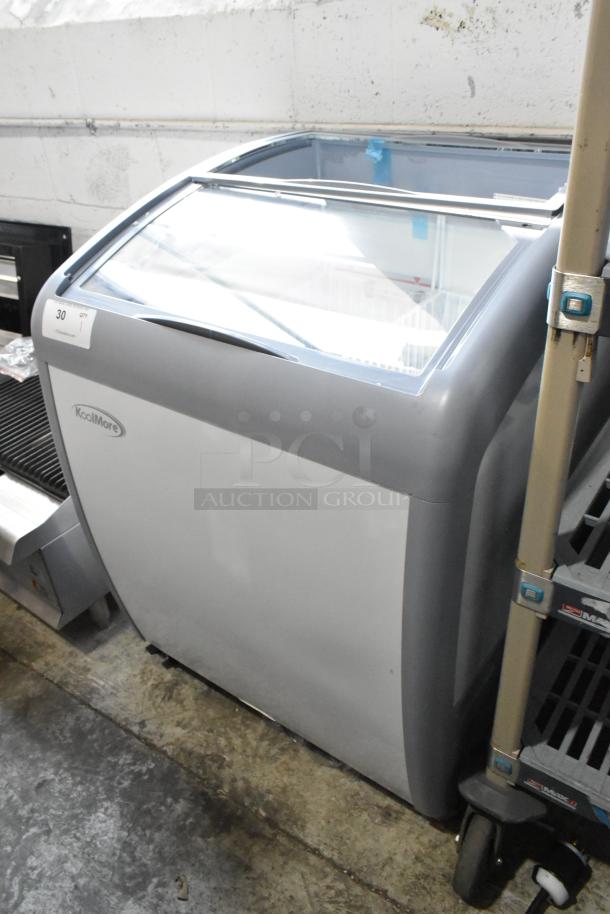 Brand new KoolMore MCF-6C display ice cream freezer, 26 in., commercial casters, broken glass sliding door visible.