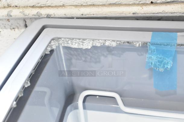 KoolMore MCF-6C ice cream freezer with broken glass sliding door. New condition; visible damage taped. 26-inch on commercial casters.