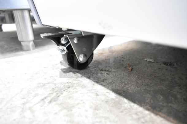 KoolMore MCF-6C ice cream freezer caster detail, black wheel on concrete.