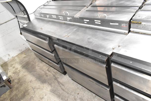 Silver King SKPZ72D stainless steel pizza prep table with 5 drawers, seen in a commercial kitchen. Slight wear visible.
