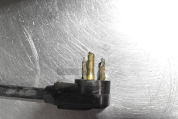 Close-up of a worn electrical plug for a Silver King SKPZ72D commercial prep table, showing damaged prongs.