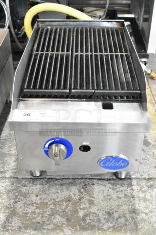 Globe stainless steel countertop gas charbroiler grill, used, with control knob and logo, auction tag visible.