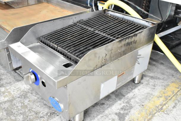 Globe stainless steel gas-powered countertop charbroiler grill, used, with control knobs and grate, visible branding tag.