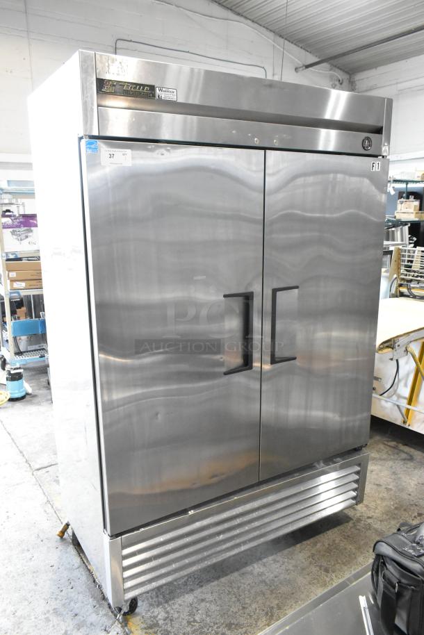 True T-49F stainless steel commercial freezer with two doors, poly-coated racks, on casters. 115V, 1 phase. Clean and sturdy.