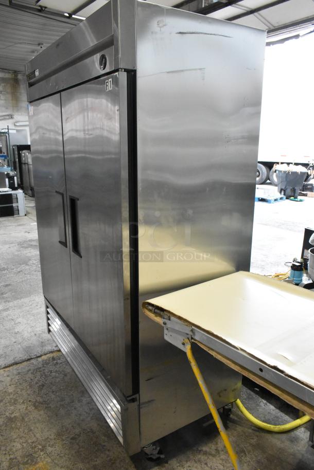 True T-49F stainless steel commercial 2-door reach-in freezer; poly coated racks, commercial casters, 115V, 1 phase.