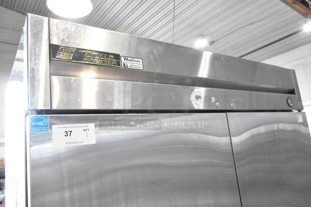 True T-49F stainless steel commercial 2-door reach-in freezer, with poly-coated racks, on casters, 115V, 1 phase.
