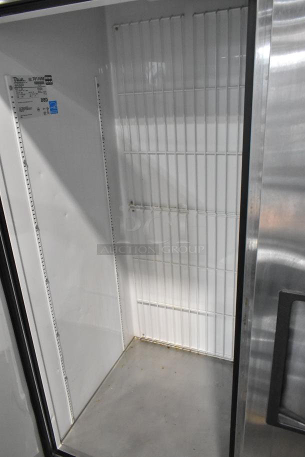 True T-49F stainless steel commercial 2-door reach-in freezer, poly-coated racks, on casters. 115V, 1 Phase. Excellent condition.