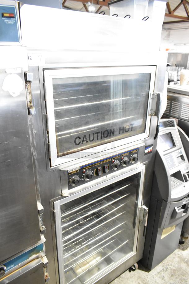 Nu Vu SUB-123 stainless steel oven proofer with "Caution Hot" label. Features dials, glass doors, on commercial casters.