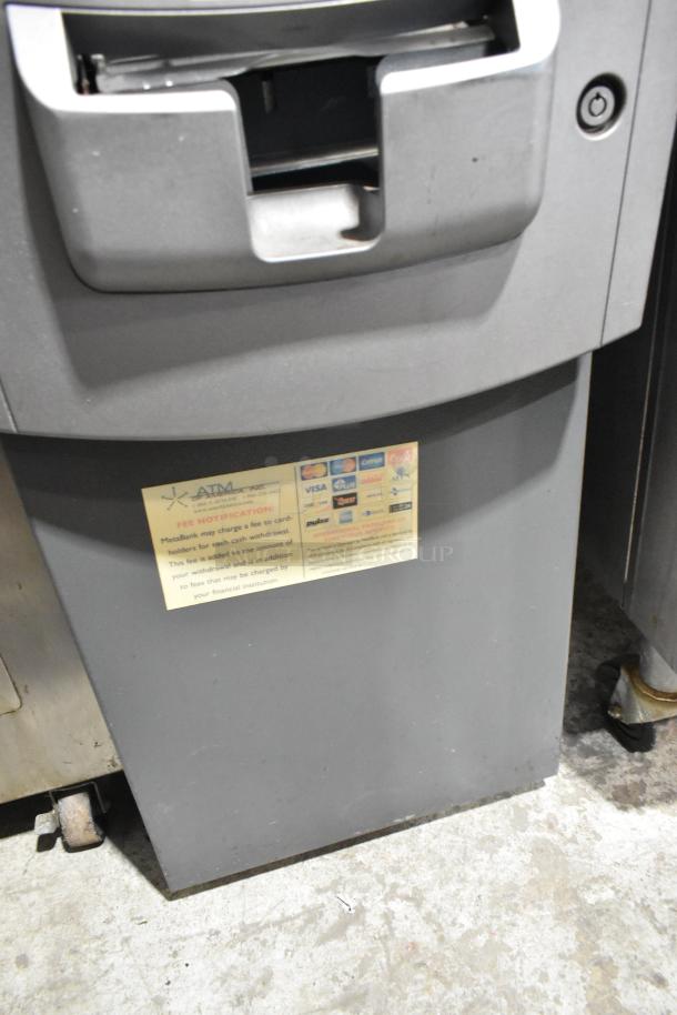 Hyosung metal floor style ATM in used condition, featuring a visible card slot and branded fee notification label.