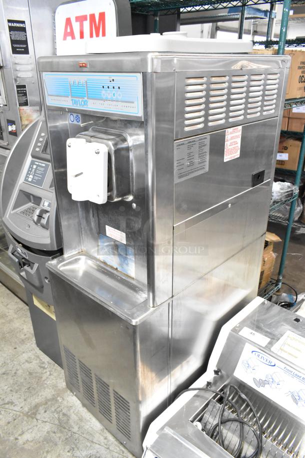 Taylor 441-27 stainless steel soft serve ice cream machine, floor model, single flavor, water-cooled, on casters.