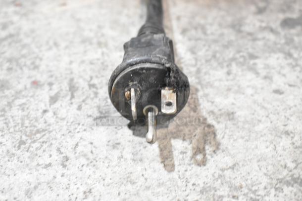 Plug of Centaur metal commercial dough mixer showing signs of wear; black three-prong plug for 208 volts.
