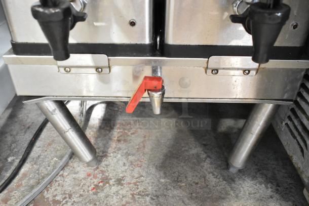 Bunn DUAL SH stainless steel commercial coffee machine with hot water dispenser, two brewers, and red faucet handle.
