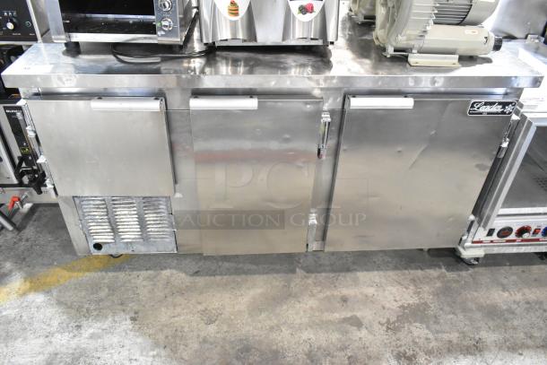 Leader LB60 S/C stainless steel 3-door undercounter cooler, commercial casters, 115V, minor dents, visible logo.