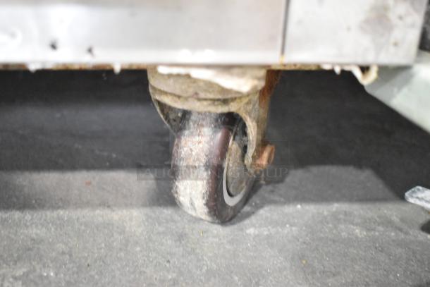 Close-up of a caster wheel from a Leader LB60 S/C stainless steel commercial undercounter cooler, indicating mobility.