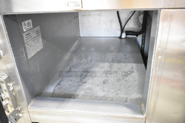 Leader LB60 S/C stainless steel commercial undercounter cooler, three doors, on casters. Interior view, slight wear visible.