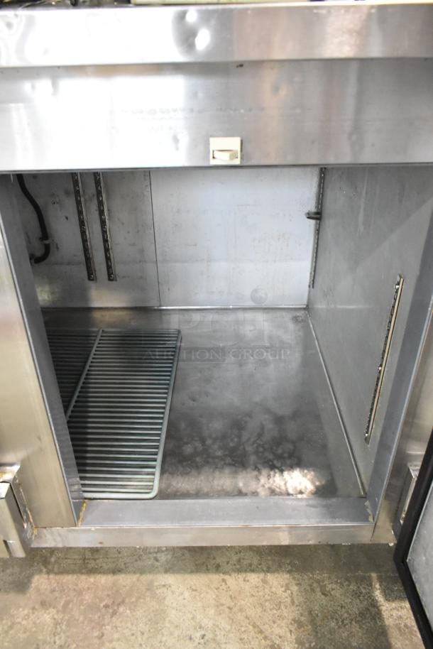 Leader LB60 S/C stainless steel 3-door undercounter cooler, commercial casters, 115V, 1 phase, interior view, used condition.