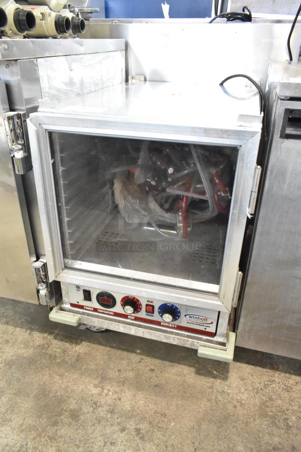 Winholt metal commercial heater proofer cabinet with controls, on casters. Visible Winholt label, moderate wear.