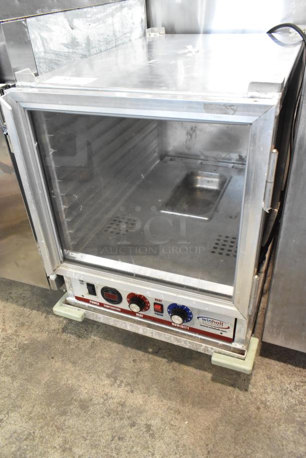 Winholt metal commercial heater proofer cabinet with glass door, adjustable controls, on commercial casters, visible wear.
