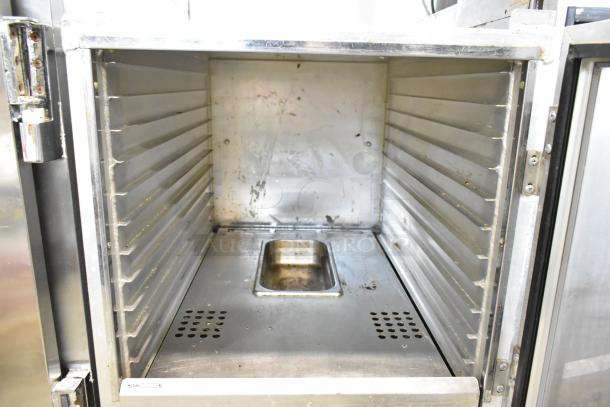 Winholt metal commercial heater proofer cabinet on casters, interior view. Used condition, showing signs of wear.