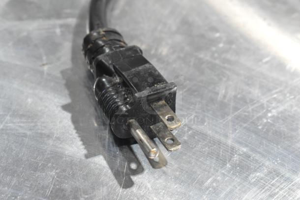 Power cord plug of a Winholt Metal Commercial Heater Proofer Cabinet, showing standard three-prong design, slightly worn.