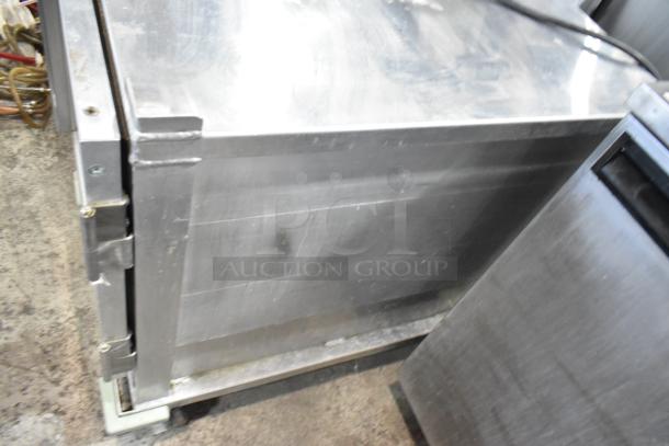 Winholt Metal Commercial Heater Proofer Cabinet, stainless steel, on commercial casters, visible wear, durable condition.