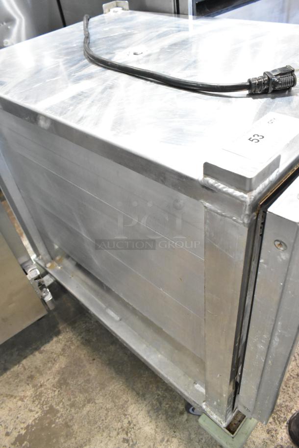 Winholt metal commercial heater proofer cabinet on casters, sturdy condition, visible power cord, label with number 53.