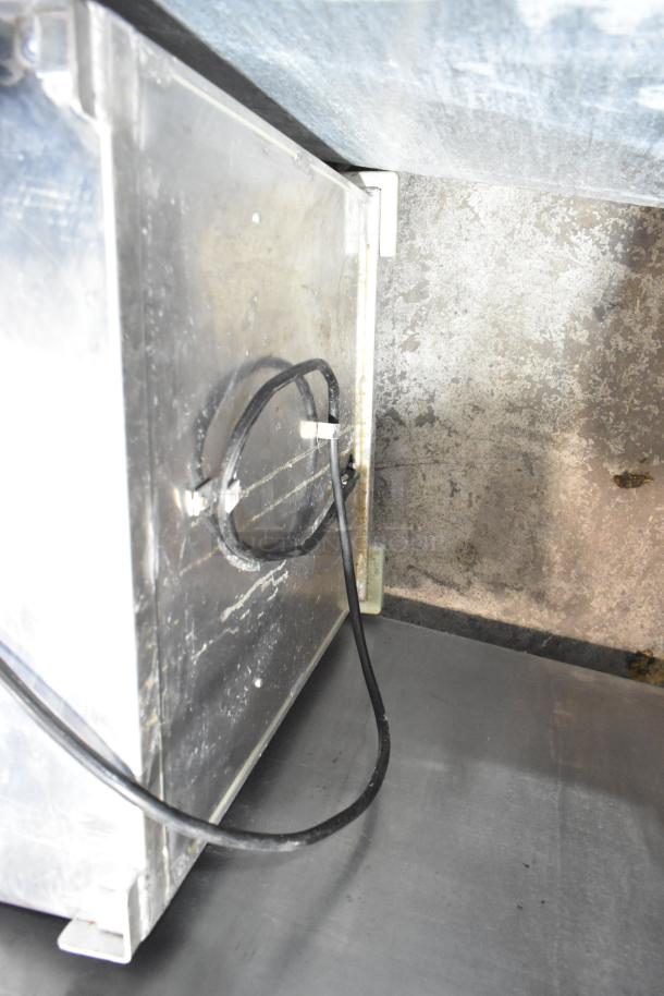 Winholt metal commercial heater proofer cabinet with casters, featuring sturdy metal construction and visible power cord.