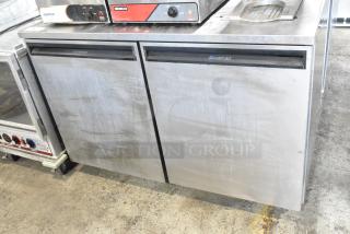 Delfield UC4048 stainless steel undercounter cooler, two doors, on casters, commercial use, 115 volts, 1 phase, visible wear.