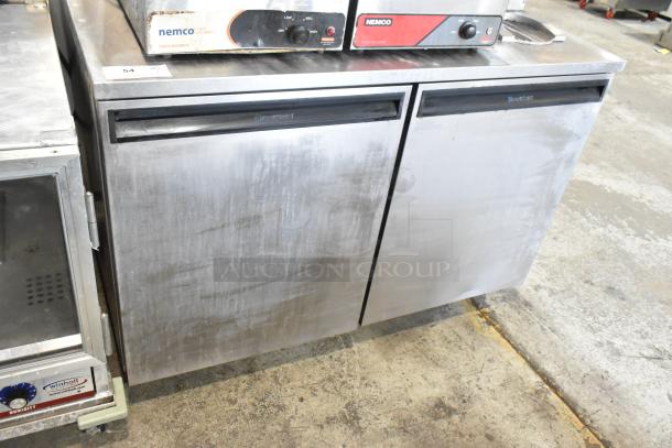Delfield UC4048 stainless steel 2-door undercounter cooler on casters, 115 volts, 1 phase, shows moderate wear.