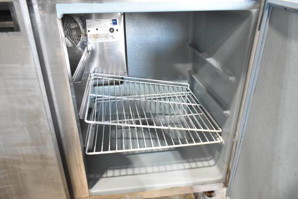 Delfield UC4048 stainless steel undercounter cooler, 2 doors, on commercial casters, interior shelves visible. 115V, 1 phase.