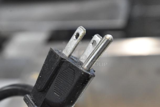 Close-up of a 120-volt plug for a Nemco 6055A stainless steel commercial countertop food warmer.