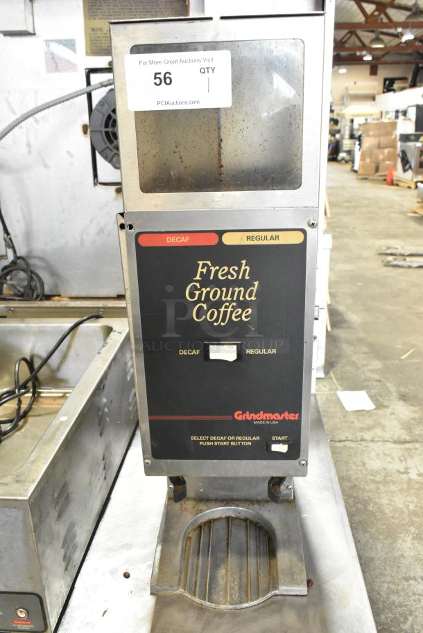 Metal commercial countertop coffee bean grinder, 120 volts, Grindmaster brand, buttons for decaf and regular, fair condition.