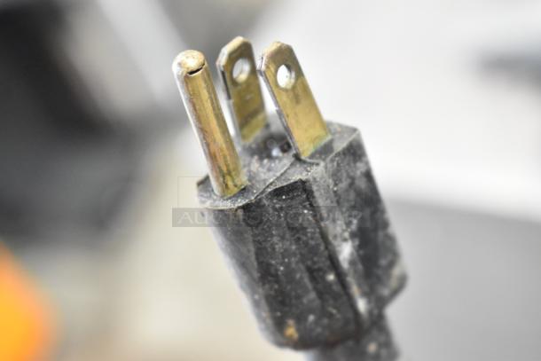 Close-up of a three-prong power plug for a metal commercial countertop coffee bean grinder, 120 volts, 1 phase.