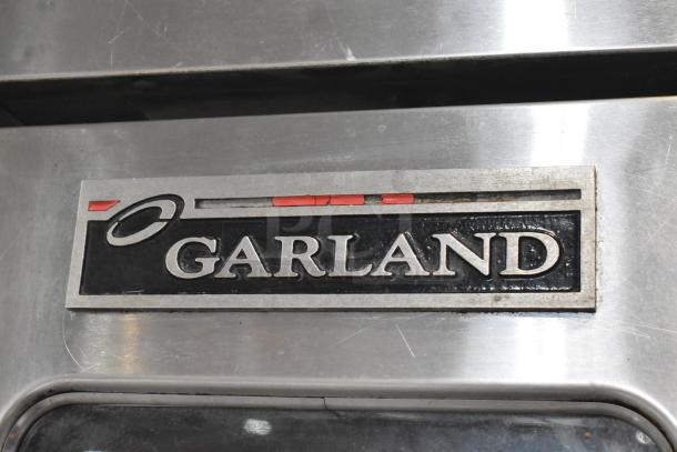 Garland Master 200 stainless steel commercial convection oven, view-through doors, metal racks, thermostatic controls, logo visible.