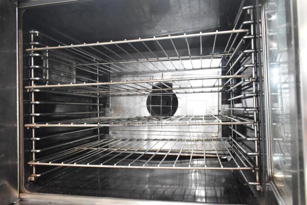 Garland Master 200 stainless steel convection oven, view through doors, metal racks, thermostatic controls, commercial use.