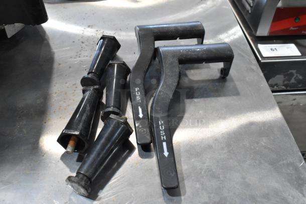 Black plastic dispenser handles and components for Bunn ULTRA-2 slushie machine, showing wear.