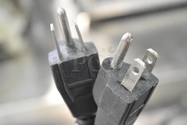 Close-up of electrical plugs for a 2019 Avantco 177P85S stainless steel commercial countertop double panini press, 120 volts.