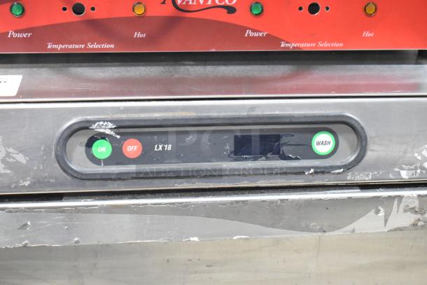 Hobart LX18H stainless steel undercounter dishwasher, visible wear, control panel with on/off and wash buttons, model label.