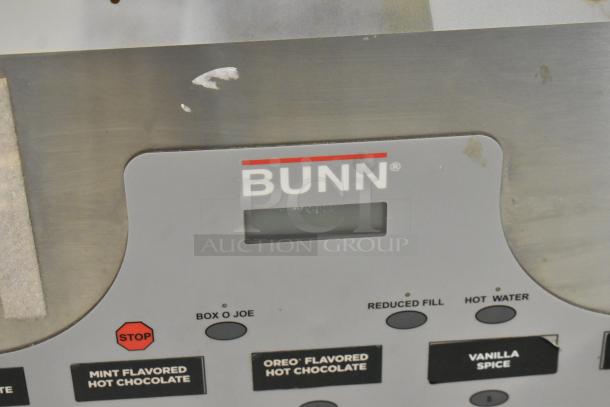 Bunn IMIX-5 stainless steel cappuccino machine control panel, showing brand logo and drink options. Some surface wear visible.