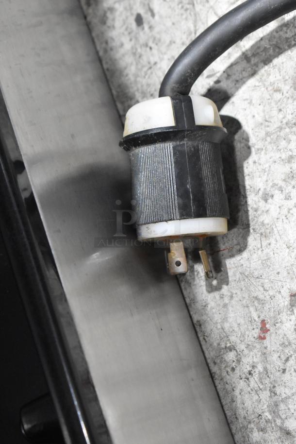 Stainless steel socket of Taylor 342D-27 frozen beverage machine, showing electrical plug connection.