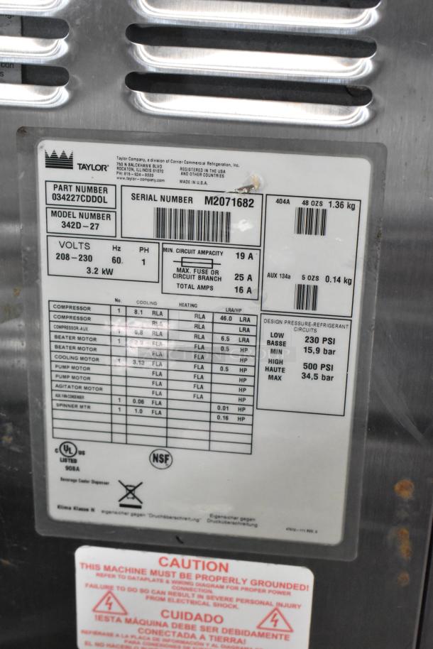 Taylor 342D-27 stainless steel beverage machine, 2-flavor, air cooled, on casters. Model, voltage, and specs label visible.