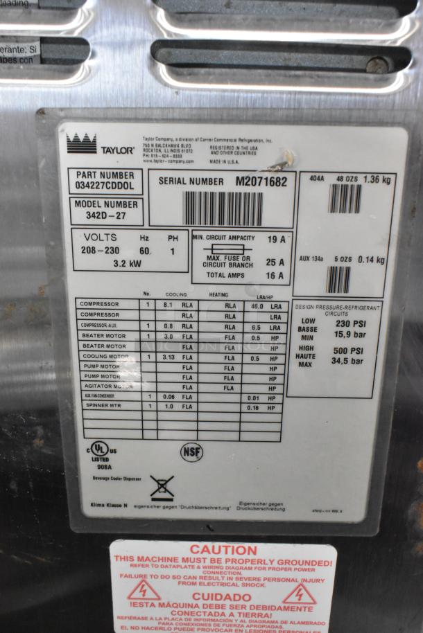 Taylor 342D-27 stainless steel 2-flavor beverage machine with mixer on casters, 208-230V, 1 phase. Model and specs visible.
