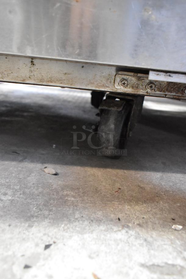 Everest ETF1 stainless steel undercounter freezer on commercial casters, shown in used condition with visible wear.