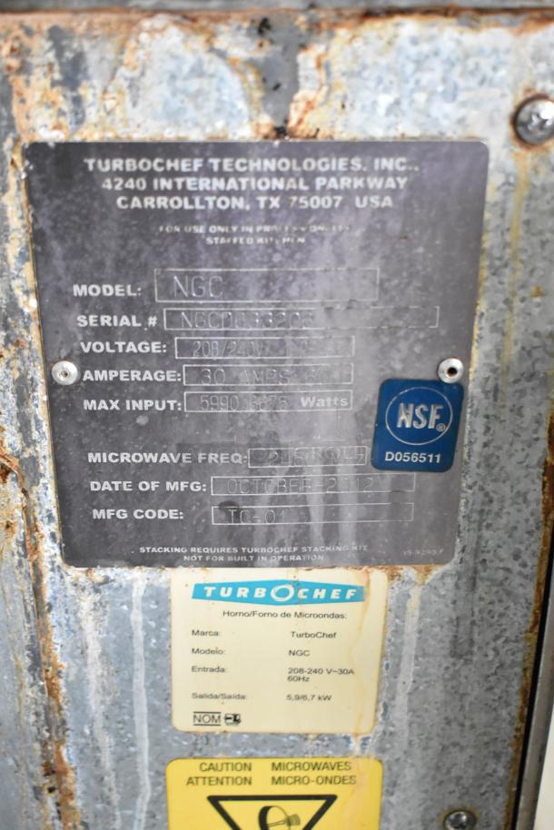 2 Turbochef NGC rapid cook ovens on stand with casters. Stainless steel. 208/240V, 1 Phase. Serial and NSF labels visible, dated October 2012.