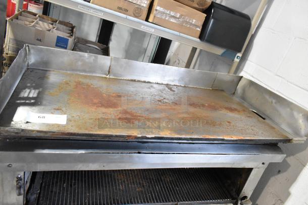 Stainless steel commercial flat top griddle with cheese melter, notable rust on surface, on equipment stand, marked lot 68.
