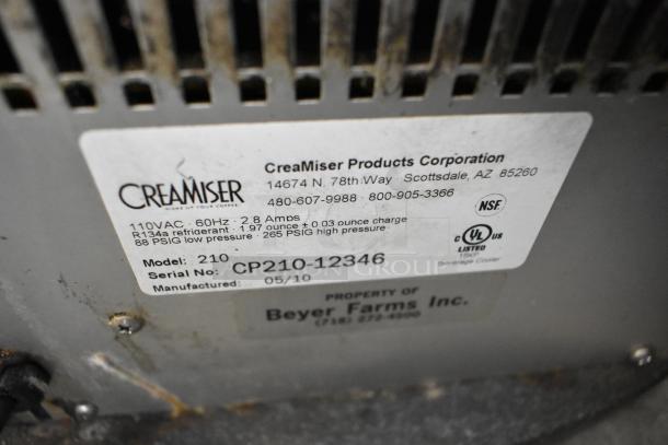 Creamiser 210 Metal Commercial Dairy Dispenser, 110V, 1 Phase. Model 210, Serial CP210-12346, manufactured 05/10. Labels indicate specs and contact details.