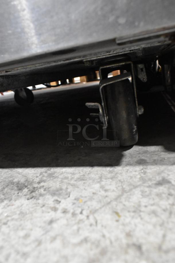 2020 Delfield 18MC32P-BI stainless steel prep table on commercial casters, showing caster detail. 115 Volts, 1 Phase.