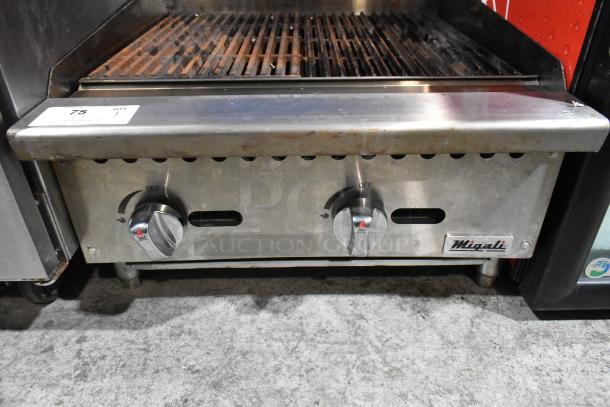 Migali stainless steel commercial countertop gas charbroiler grill with dual control knobs, slight wear, ID tag visible.