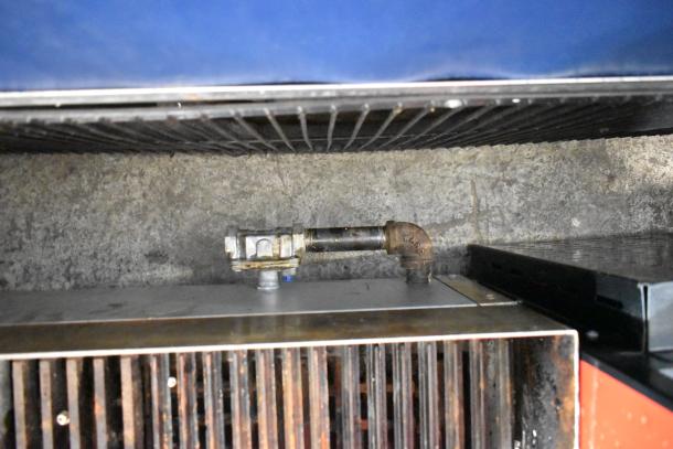 Migali stainless steel commercial countertop gas charbroiler grill, showing burner and grill components, in used condition.