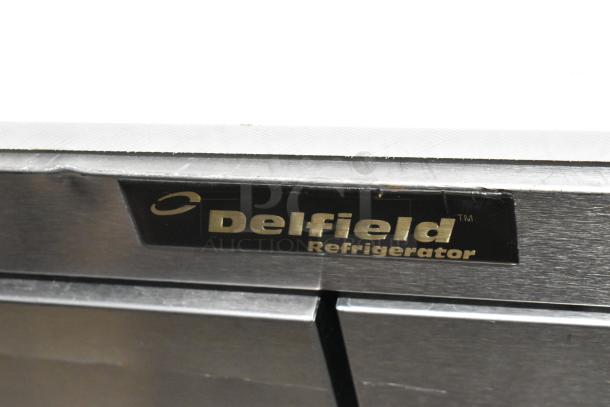 Delfield stainless steel prep table with 4 drawers, over shelf, and Bain Marie mega top; label shows brand. 115V, 1 phase.